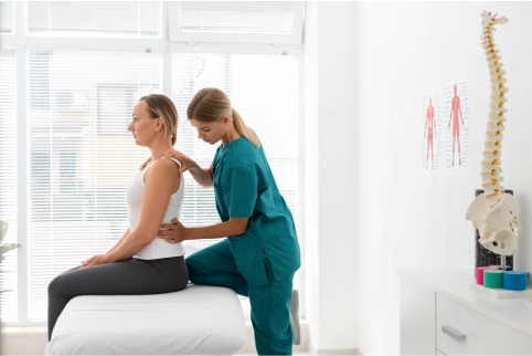 women helps physio back therapy