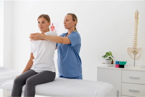 physiotherapist helping female patient